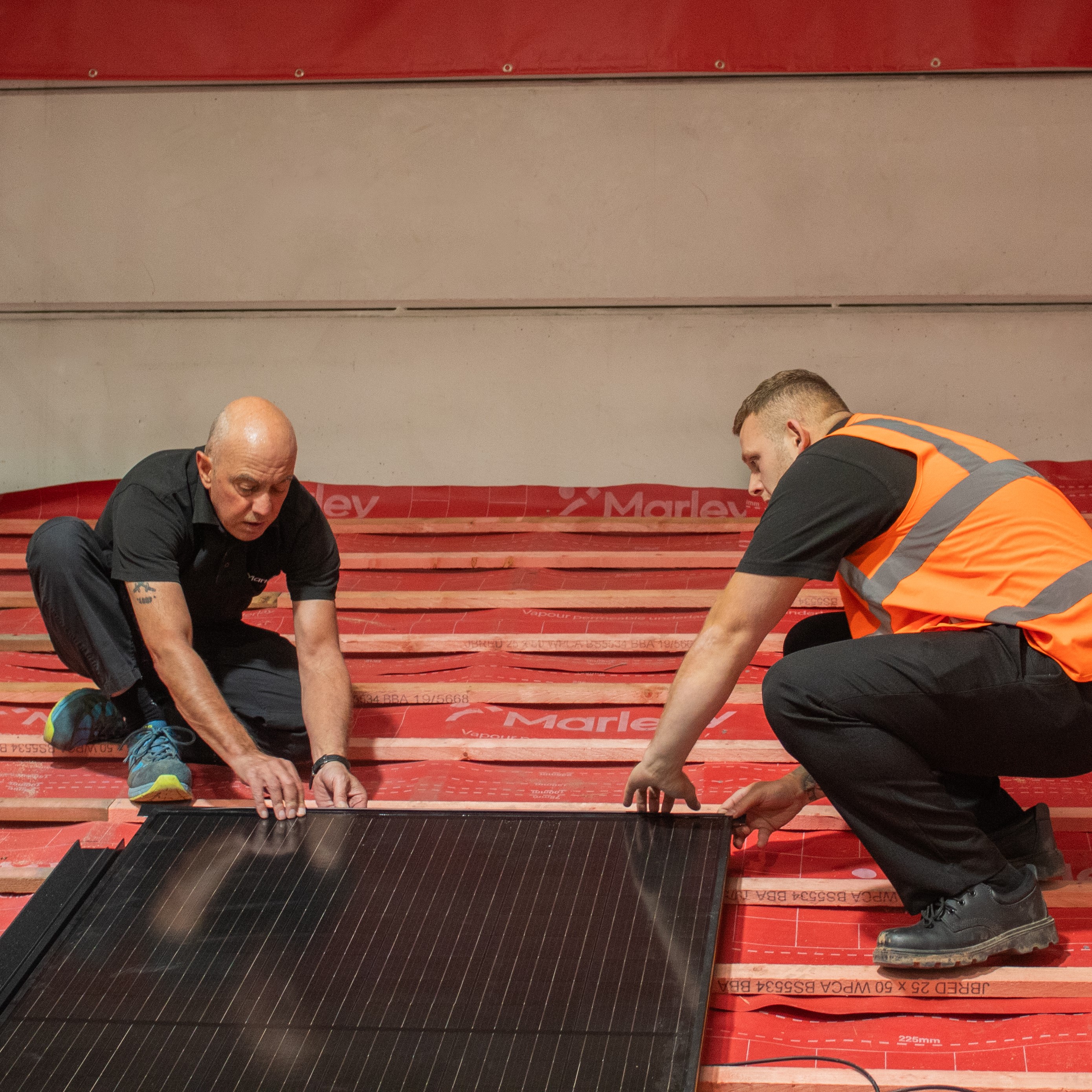 Kevin Taylor (left) teaching how to install solar panels