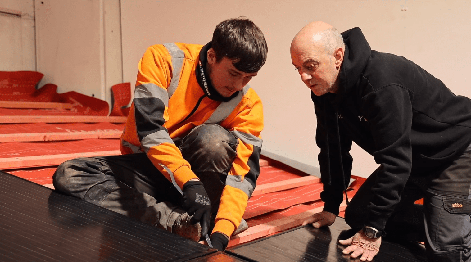 Kevin Taylor (right) helping a student of the solar installation training course 